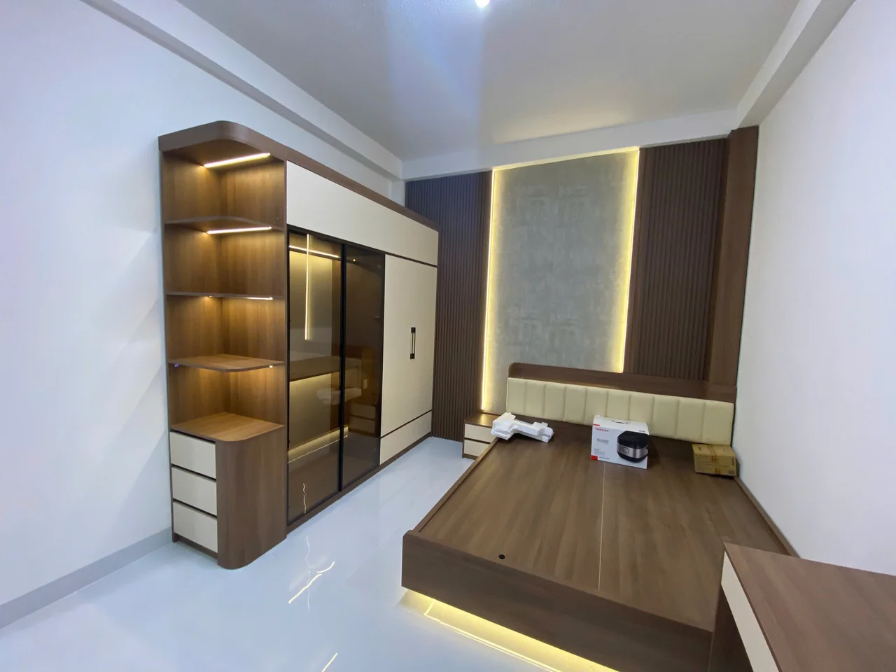Phòng ngủ với tủ áo, kệ hở và giường; không suy ra có gương từ cánh bóng